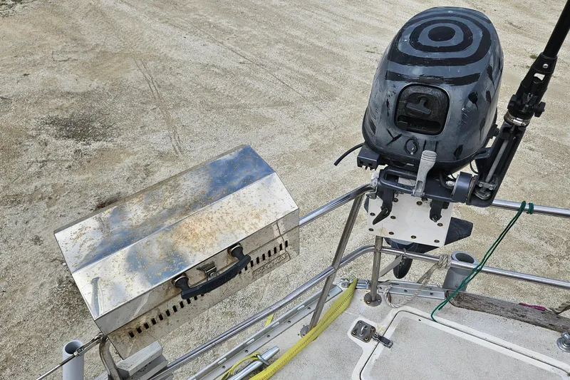 Slide: The Image of 1980 Morgan 462 sailboat with red sails and covered cockpit, docked in a marina. - 66