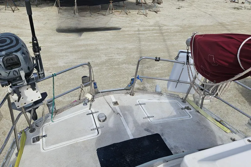 Slide: The Image of 1982 Morgan 462 sailboat deck with equipment, docked on sandy ground. - 12