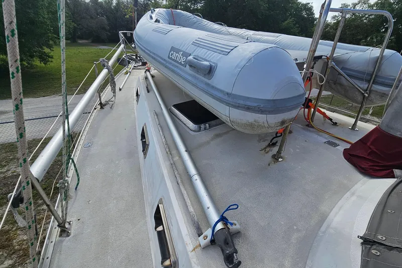 Slide: The Image of Deck of 1982 Morgan 462 sailboat with inflatable dinghy and rigging. - 23