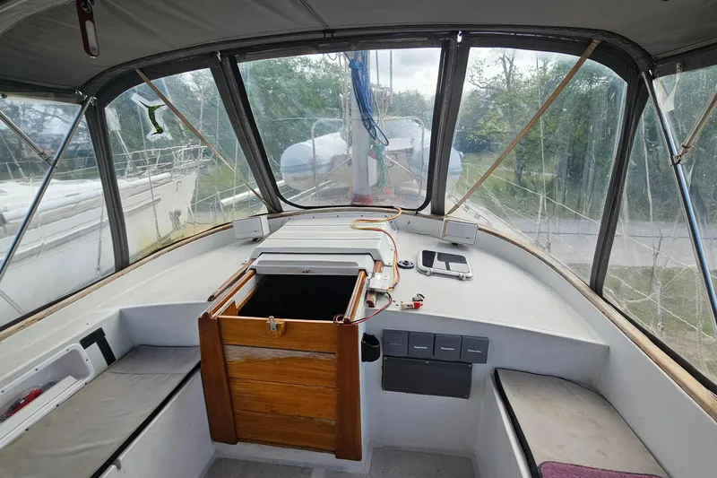 Slide: The Image of Interior view of a 1982 Morgan 462 sailboat cockpit with wooden hatch and navigation equipment. - 26