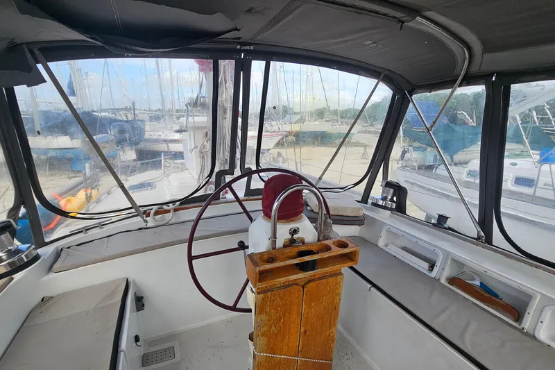 Slide: The Image of Interior view of a 1982 Morgan 462 sailboat cockpit with steering wheel and seating. - 27