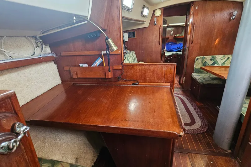 Slide: The Image of 1982 Morgan 462 yacht interior with wooden furnishings and cozy seating area. - 34