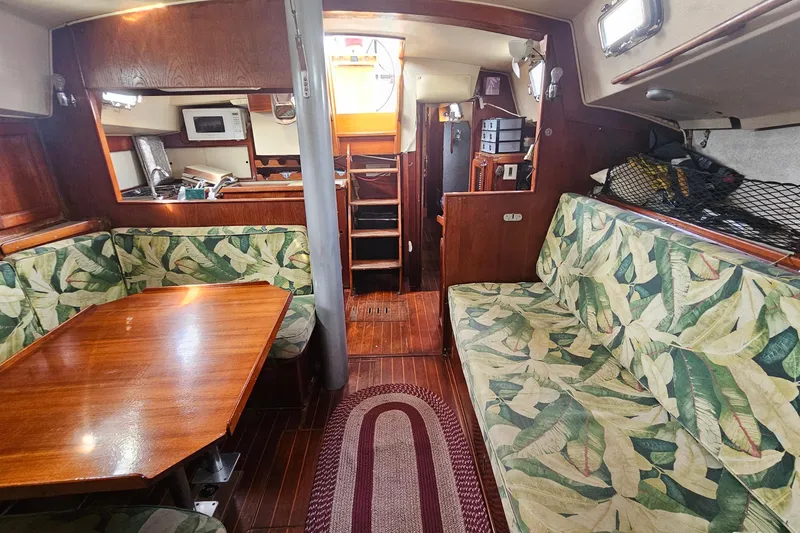 Slide: The Image of Interior of a 1982 Morgan 462 sailboat with tropical-patterned seating and wooden finishes. - 47