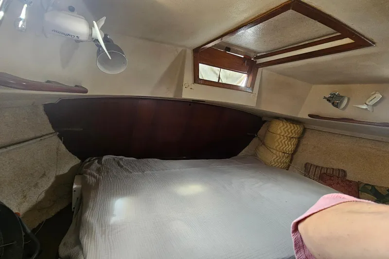 Slide: The Image of Cozy cabin interior of a 1982 Morgan 462 sailboat with bed and porthole. - 56