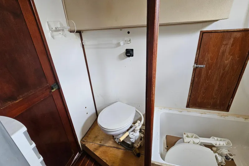 Slide: The Image of 1982 Morgan 462 yacht bathroom with wooden accents and marine toilet. - 59