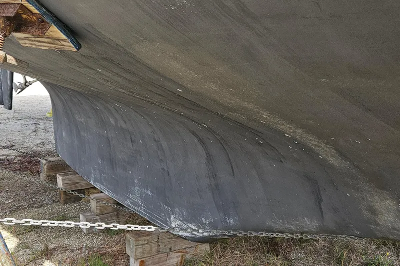 Slide: The Image of Bottom view of a 1982 Morgan 462 sailboat hull on wooden supports. - 6