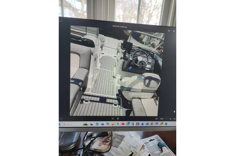 Slide: The Image of Interior view of a 2012 Yamaha Boats AR240 HO, showcasing seating and steering area. - 3