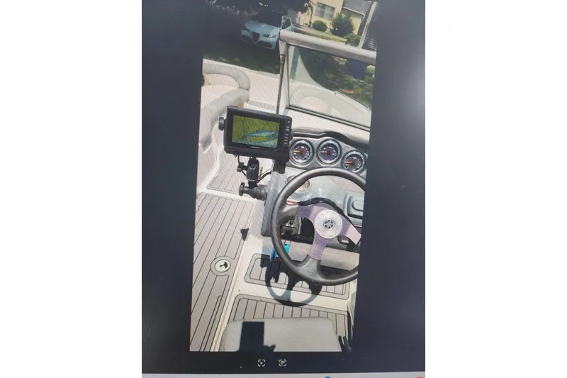 Slide: The Image of 2012 Yamaha Boats AR240 HO dashboard with steering wheel and navigation display. - 4