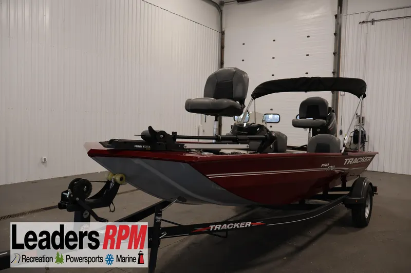 The Image of 2022 Tracker Pro 170 boat in showroom, featuring Minn Kota motor and trailer. - 1