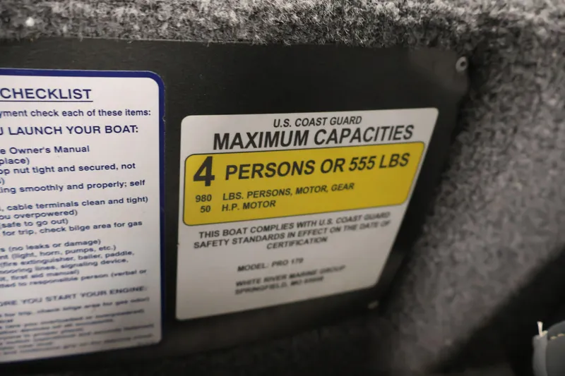 Slide: The Image of 2022 Tracker Pro 170 capacity label, 4 persons or 555 lbs, U.S. Coast Guard compliant. - 24
