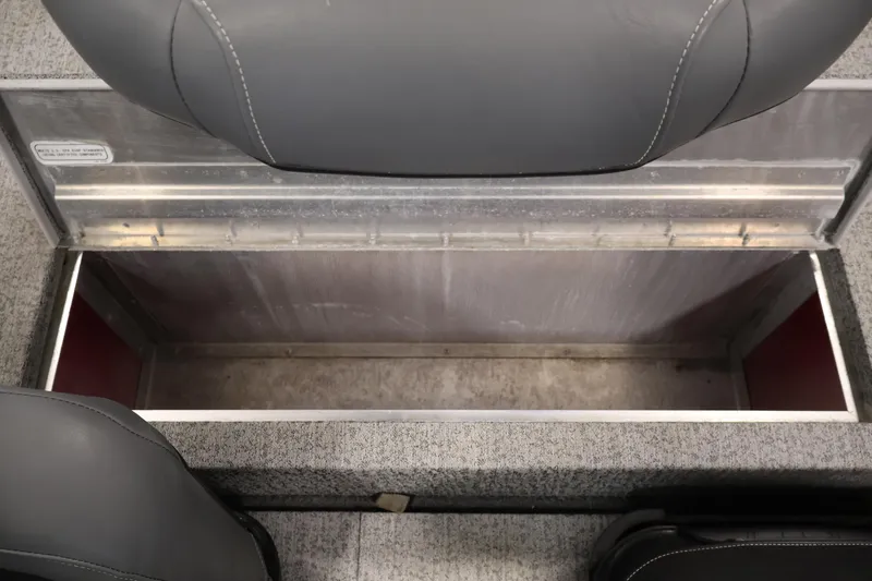 Slide: The Image of 2022 Tracker Pro 170 boat storage compartment with gray seating and metal interior. - 27