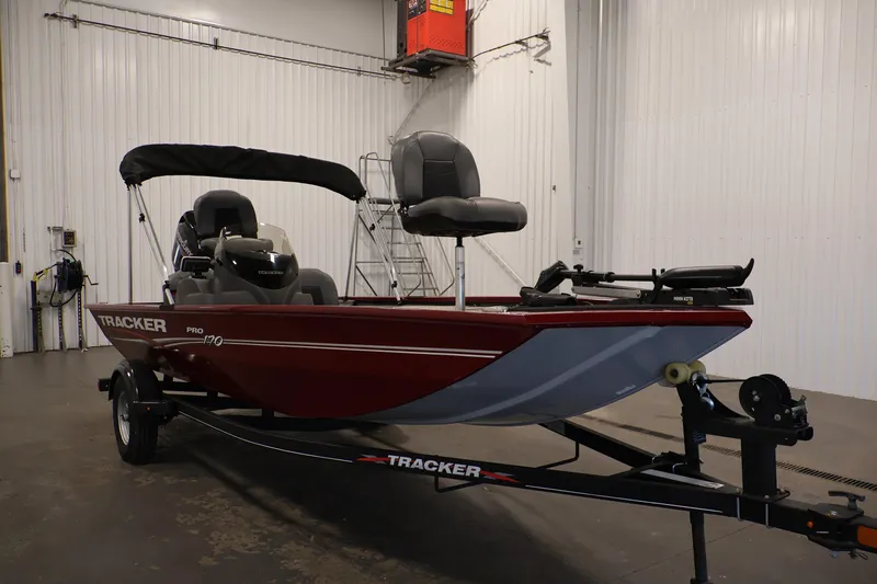 Slide: The Image of 2022 Tracker Pro 170 boat in a garage, featuring a sleek red design. - 3