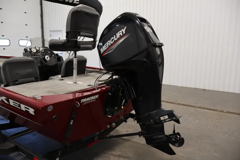 Slide: The Image of 2022 Tracker Pro 170 boat with Mercury outboard motor in a garage. - 30