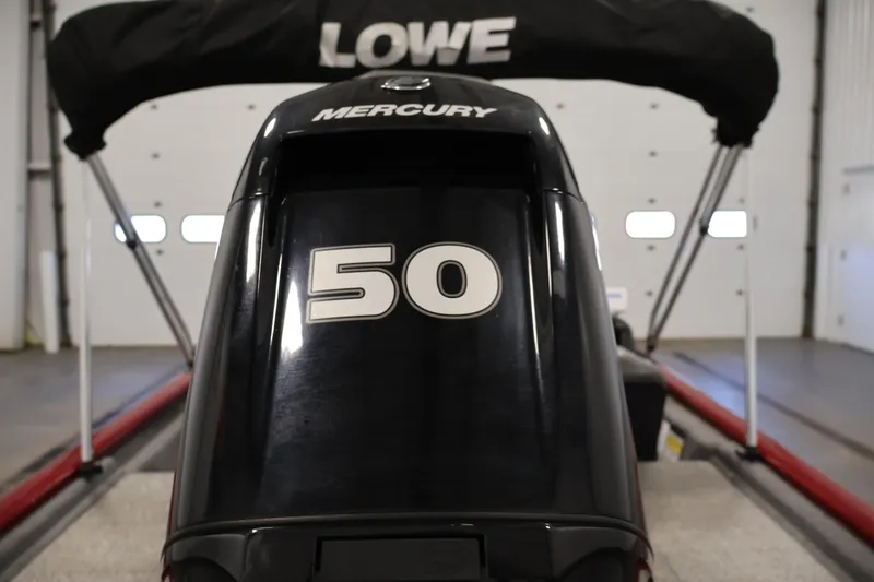 Slide: The Image of 2022 Tracker Pro 170 boat with Mercury 50 horsepower engine in a garage. - 31