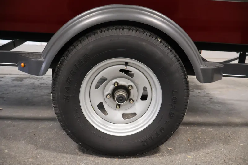 Slide: The Image of 2022 Tracker Pro 170 trailer wheel with Karrier tire on concrete surface. - 35