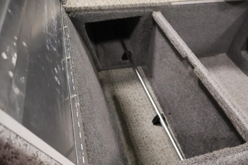 Slide: The Image of Interior storage compartment of 2022 Tracker Pro 170 boat, featuring carpeted sections. - 37