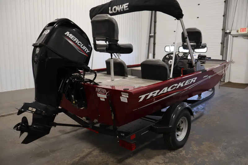 Slide: The Image of 2022 Tracker Pro 170 boat with Mercury engine in a garage setting. - 5