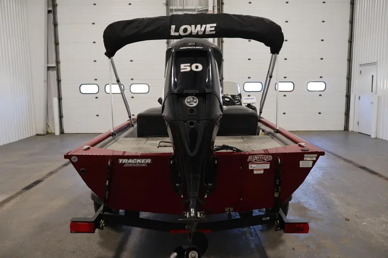 Slide: The Image of 2022 Tracker Pro 170 boat with Mercury 50 engine in a garage setting. - 6
