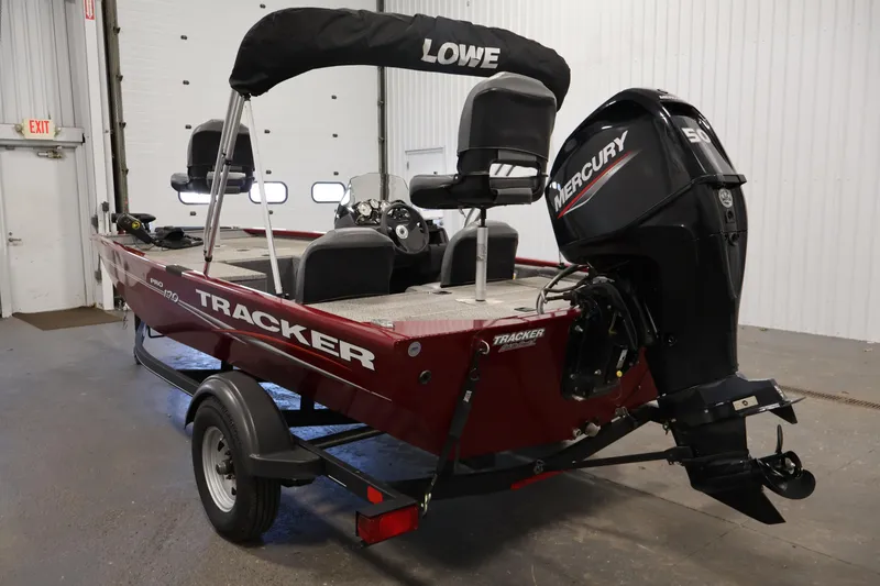 Slide: The Image of 2022 Tracker Pro 170 boat with Mercury engine in a garage setting. - 7