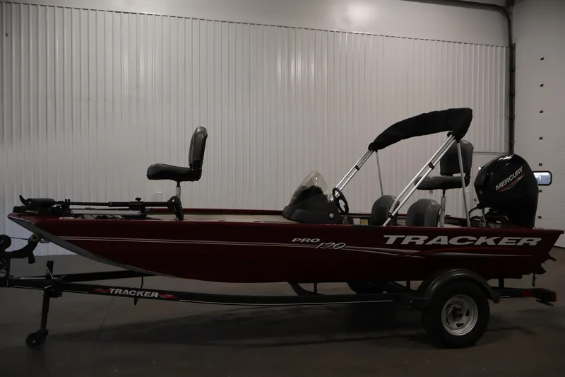Slide: The Image of 2022 Tracker Pro 170 boat with Mercury engine in indoor setting. - 8