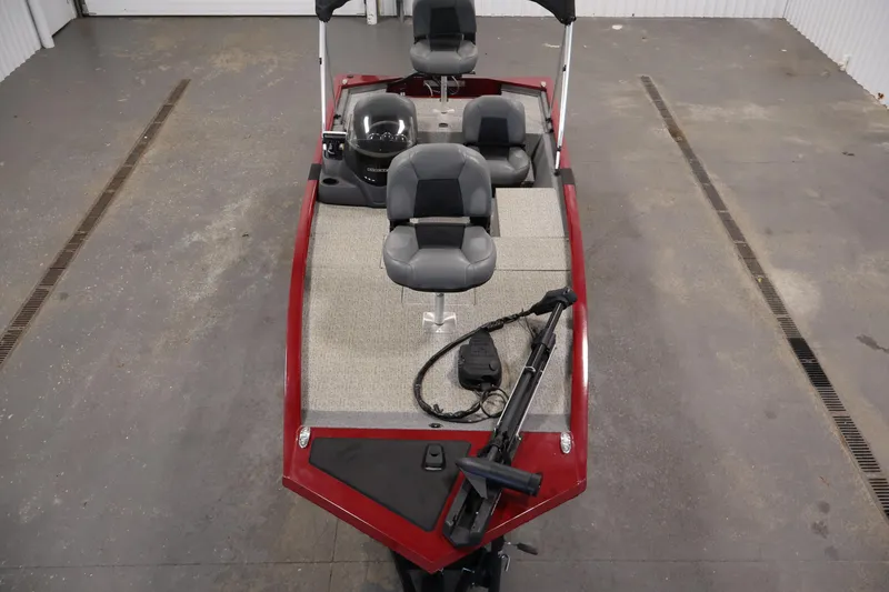 Slide: The Image of 2022 Tracker Pro 170 boat interior with seating and steering console in a garage. - 9