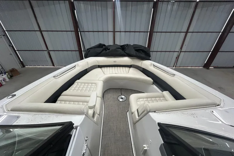 Slide: The Image of 2017 Cobalt R30 boat interior with white cushioned seating in a storage facility. - 11