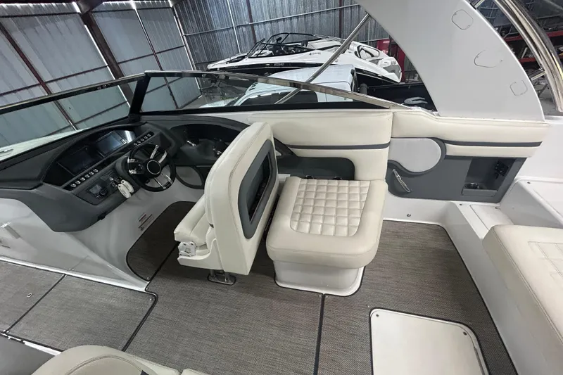 Slide: The Image of 2017 Cobalt R30 boat interior with modern helm and plush seating in a storage facility. - 14