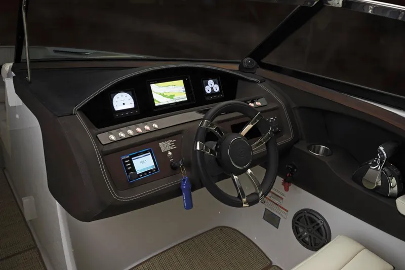 Slide: The Image of Manufacturer Provided Image: 2017 Cobalt R30 boat dashboard with steering wheel and navigation screens. - 3