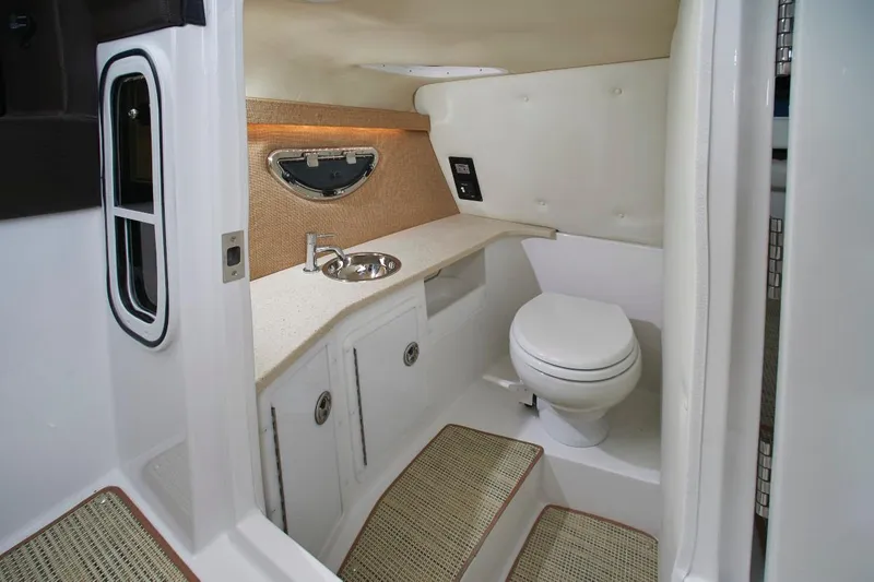 Slide: The Image of Interior of a 2017 Cobalt R30 boat with white cushioned seating. - 9
