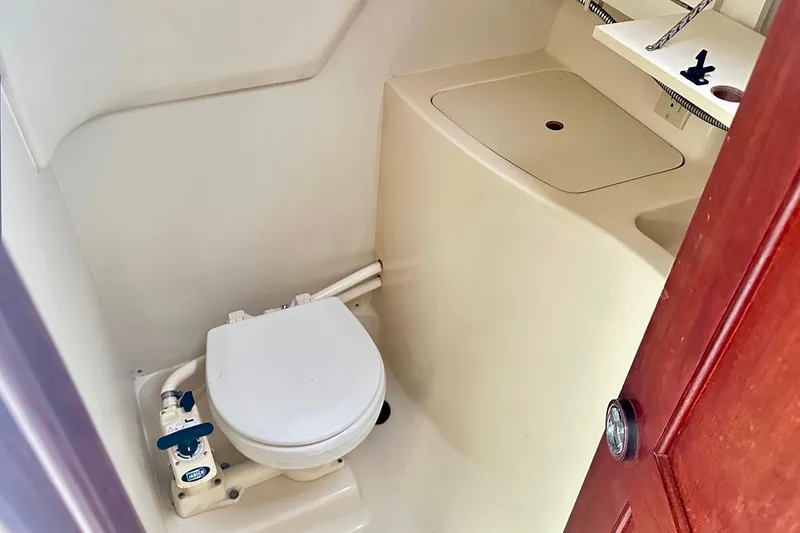 Slide: The Image of Compact marine bathroom in 1996 Hunter Marine 280 sailboat, featuring toilet and sink. - 12
