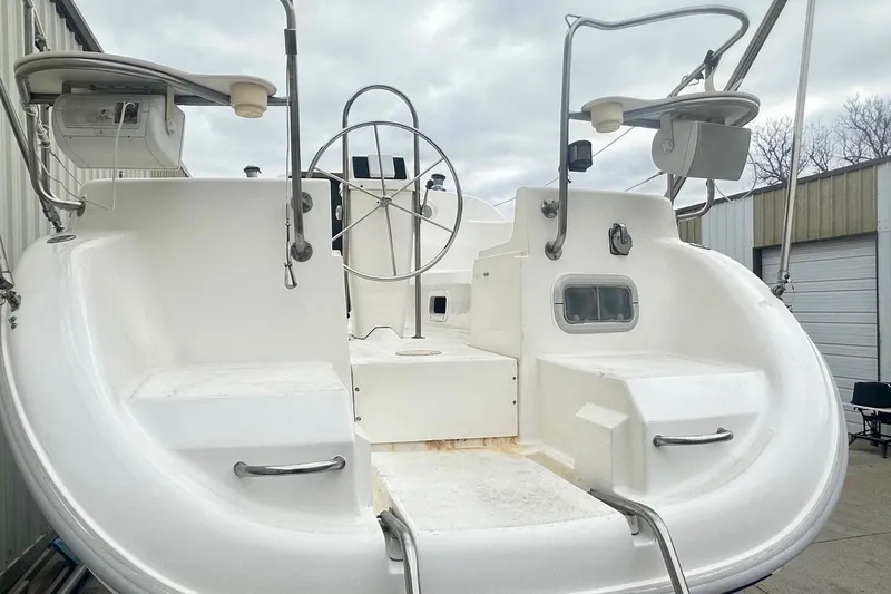 Slide: The Image of Cockpit of a 1996 Hunter Marine 280 sailboat with steering wheel and seating. - 3