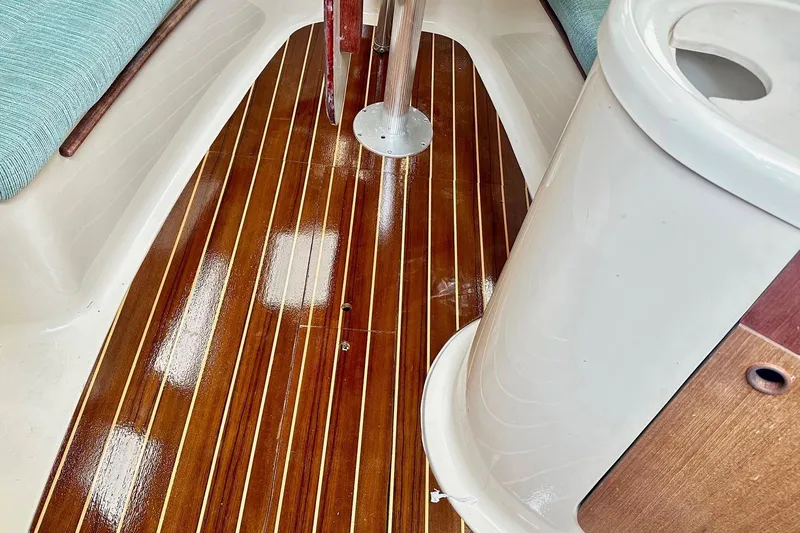Slide: The Image of Polished wooden floor inside 1996 Hunter Marine 280 sailboat cabin. - 4