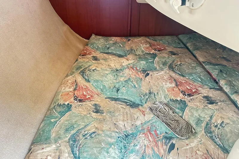 Slide: The Image of Interior cabin of 1996 Hunter Marine 280 with abstract patterned bedding. - 6