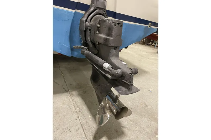 Slide: The Image of 1993 Limestone Express boat outboard motor with propeller in a garage setting. - 11