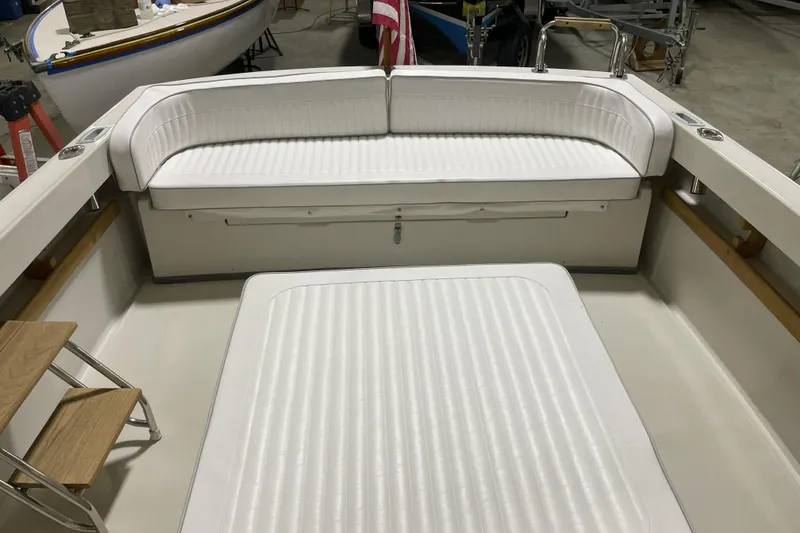 Slide: The Image of 1993 Limestone Express boat interior with white cushioned seating and wooden steps. - 5