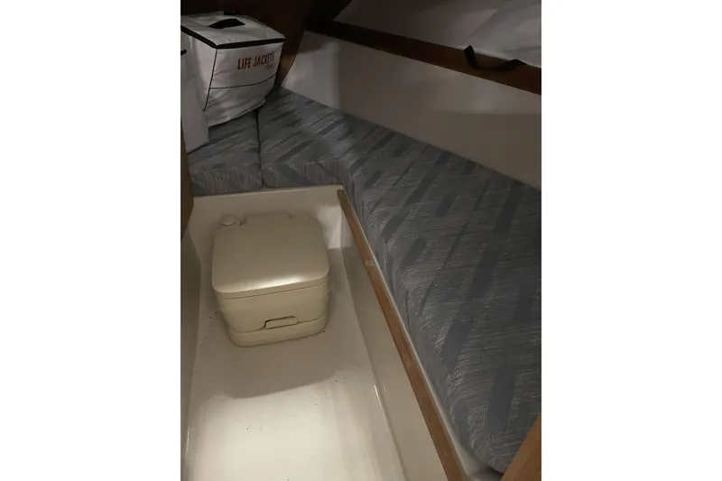 Slide: The Image of 1993 Limestone Express boat interior with portable toilet and life jackets. - 9