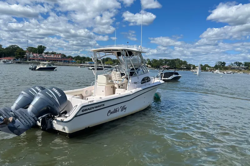 Slide: The Image of 2005 Grady-White Islander 270 boat on water, twin Yamaha engines, clear sky. - 2