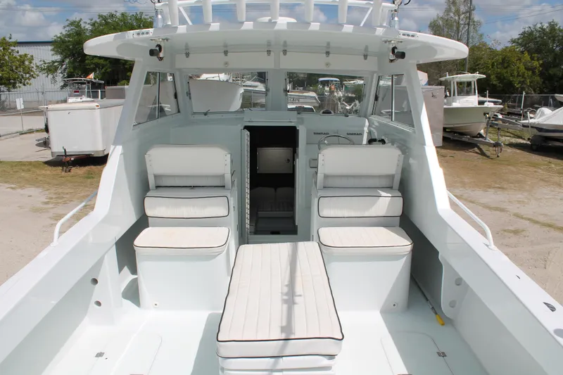 Slide: The Image of 2015 Stamas Americana 26 boat interior with cushioned seating and open cabin. - 10
