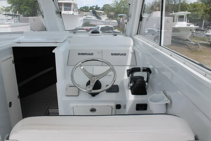 Slide: The Image of Helm of 2015 Stamas Americana 26 boat with Simrad electronics and steering wheel. - 12