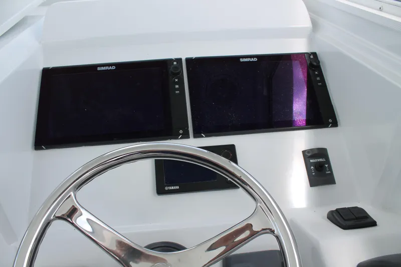 Slide: The Image of Steering console of 2015 Stamas Americana 26 with Simrad displays and Yamaha controls. - 13
