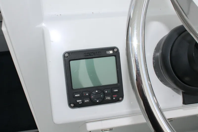 Slide: The Image of Steering wheel and control panel on 2015 Stamas Americana 26 boat. - 14