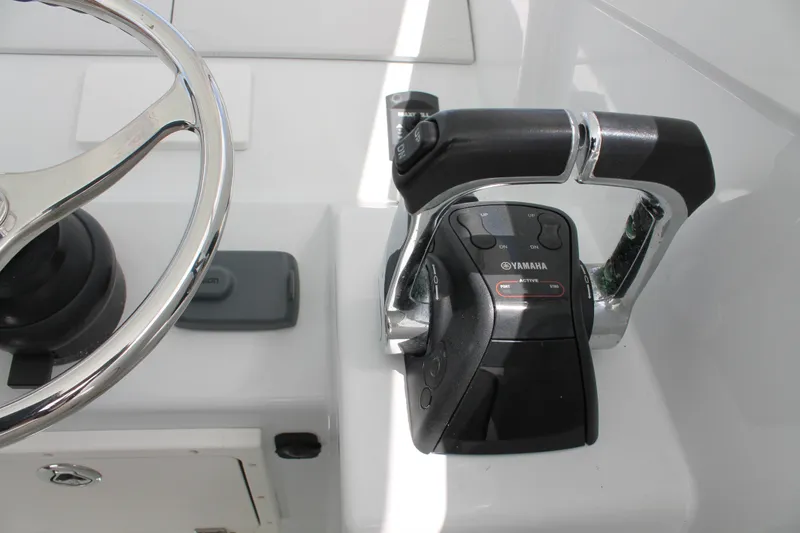 Slide: The Image of Steering wheel and Yamaha throttle controls on 2015 Stamas Americana 26 boat. - 16