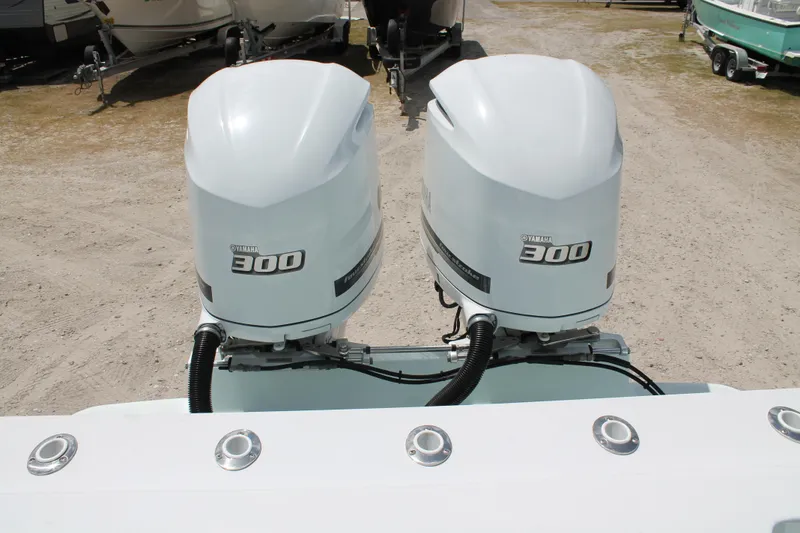 Slide: The Image of Twin Yamaha 300 engines on a 2015 Stamas Americana 26 boat. - 27