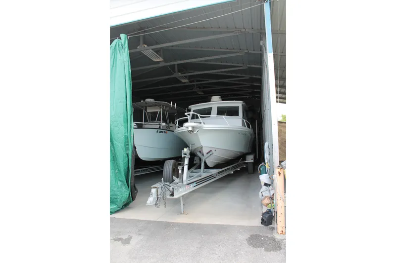 Slide: The Image of 2015 Stamas Americana 26 boat stored in a garage on a trailer. - 29