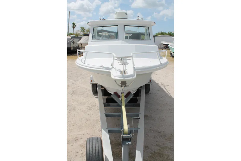 Slide: The Image of 2015 Stamas Americana 26 boat on trailer under cloudy sky. - 3