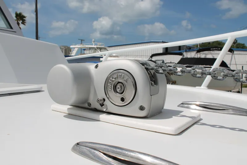 Slide: The Image of Anchor windlass on 2015 Stamas Americana 26 boat deck under clear sky. - 4