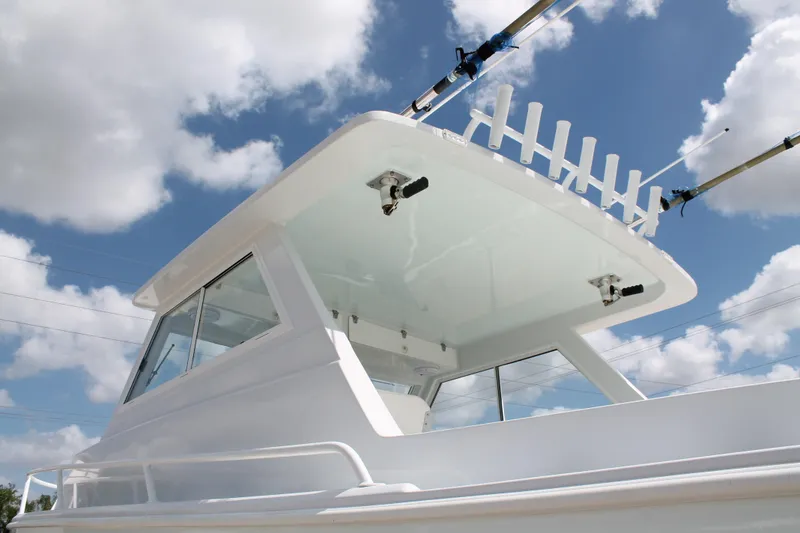 Slide: The Image of 2015 Stamas Americana 26 boat with fishing rod holders against a cloudy sky. - 8