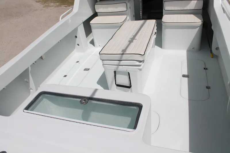 Slide: The Image of 2015 Stamas Americana 26 boat interior with seating and storage compartments. - 9