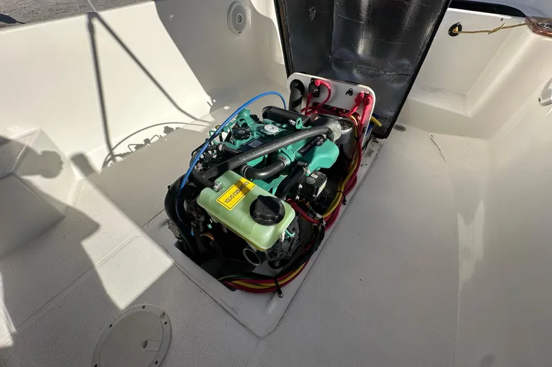 Slide: The Image of Engine compartment of a 2015 Ranger Tugs R-21 EC boat, showcasing detailed wiring and components. - 13