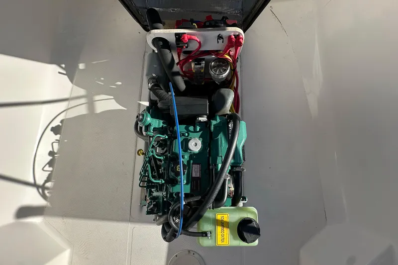 Slide: The Image of Engine compartment of a 2015 Ranger Tugs R-21 EC boat, showcasing mechanical components. - 15